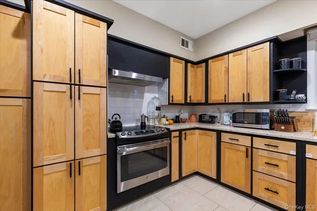 a kitchen with a refrigerator and a sink