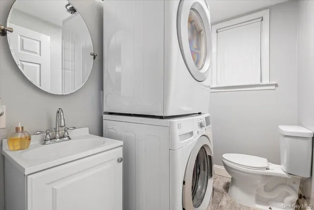 a bathroom with a sink mirror and toilet