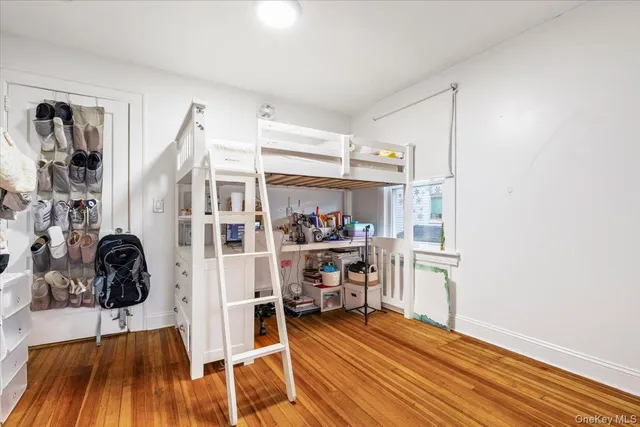 a view of a livingroom with wooden floor and furniture