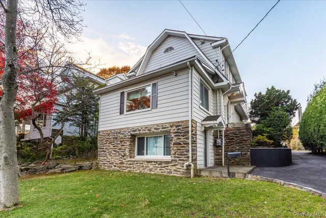 a front view of house with a garden