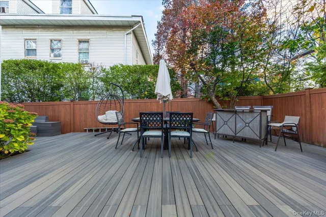 a view of a patio with table and chairs and wooden floor
