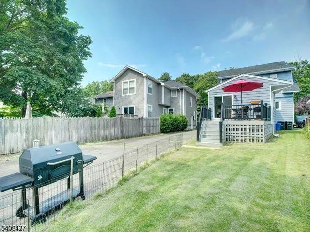 a view of a house with a yard and sitting area