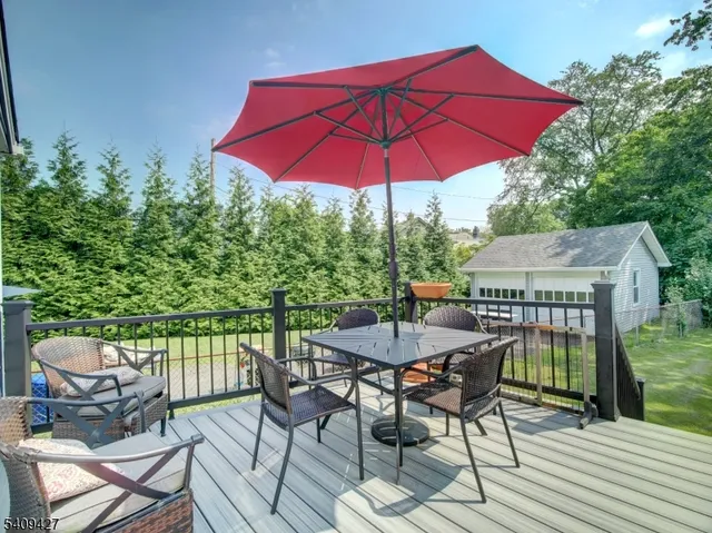 a view of a patio with furniture and a backyard