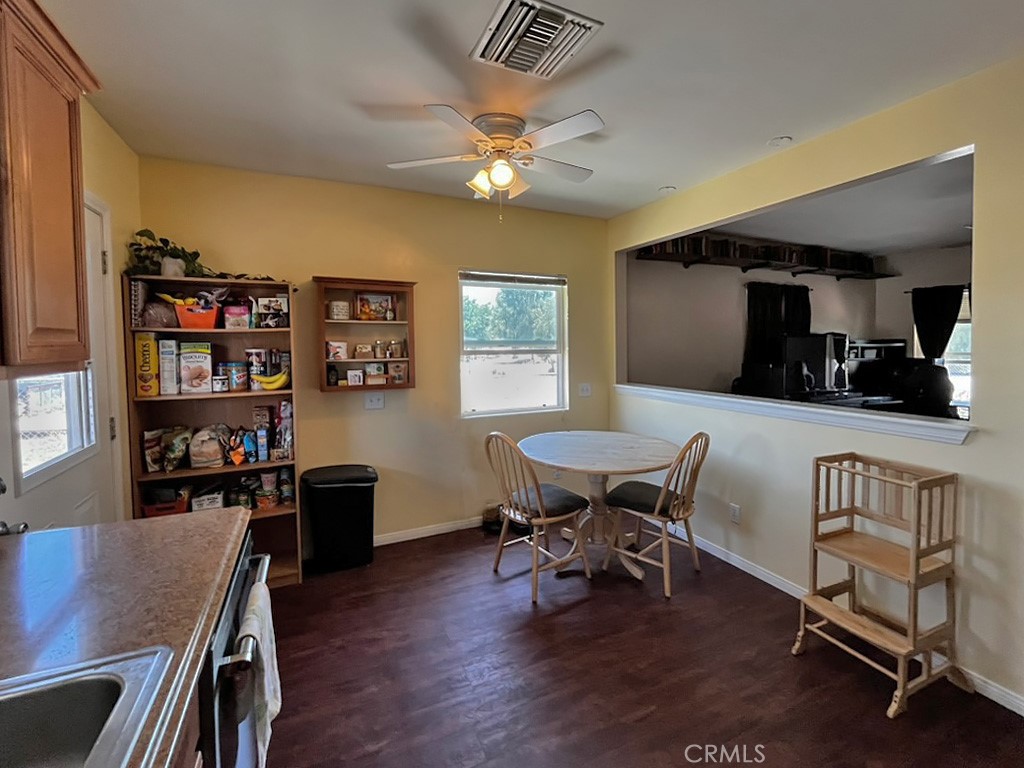 1205 Opal Way Mentone, CA 92359 - Photo 5 of 17 a view of a dining room with furniture and wooden floor