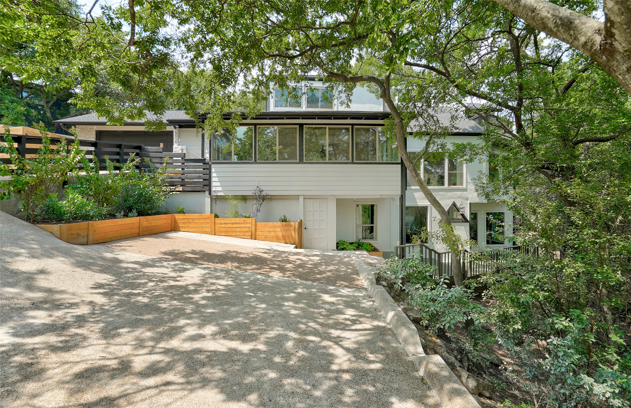 8804 Mountain Ridge Drive, Unit B Austin, TX 78759 - Photo 17 of 17 A gracefully designed multi-level dwelling, nestled amongst verdant trees, offers a private, welcoming entrance.