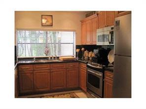 6115 Via Laguna Lane Boca Raton, FL 33433 - Photo 13 of 14 a kitchen with a sink a stove and cabinets