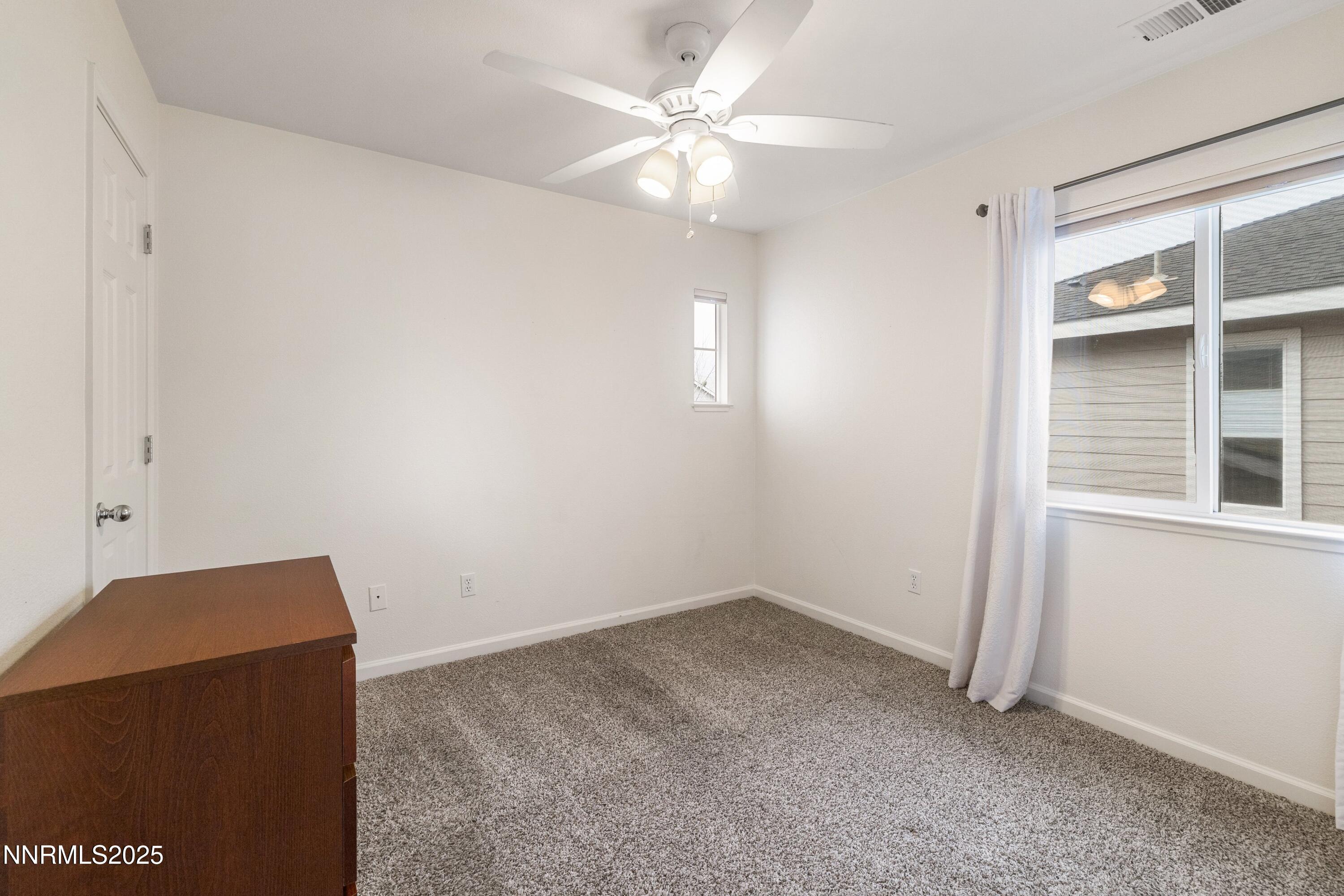 9294 Lone Wolf Circle Reno, NV 89506 - Photo 14 of 25 an empty room with windows and fan