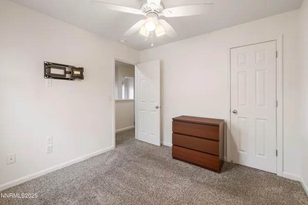an empty room with a cabinet and mirrors