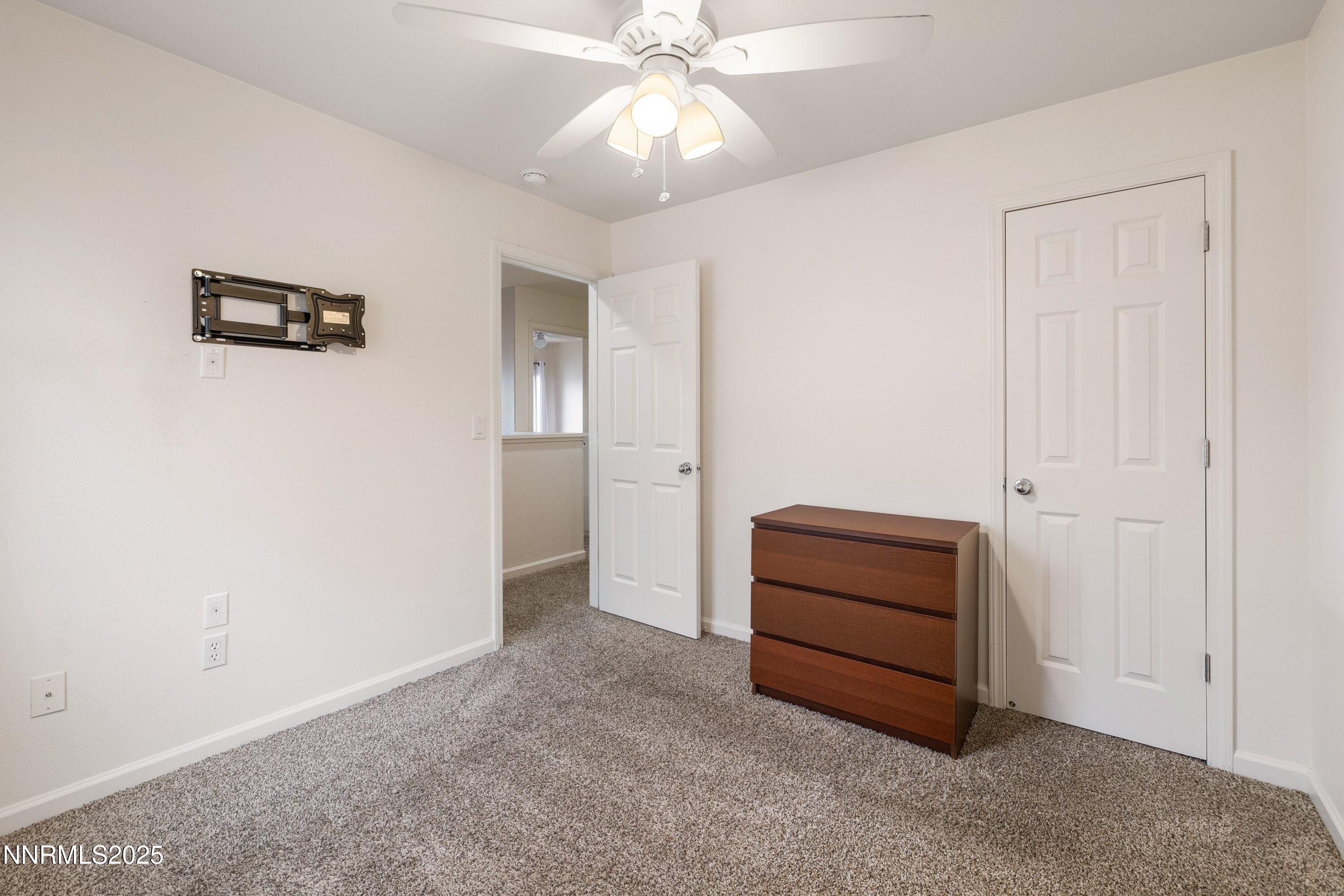 9294 Lone Wolf Circle Reno, NV 89506 - Photo 15 of 25 an empty room with a cabinet and mirrors