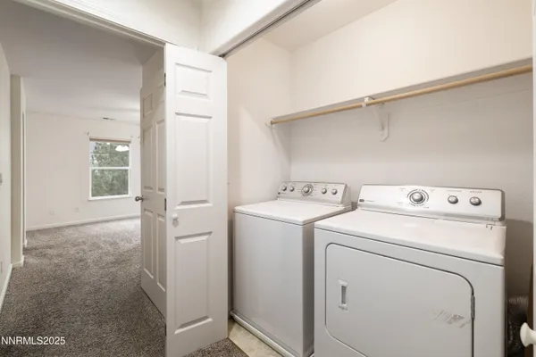 a view of storage and utility room with washer and dryer