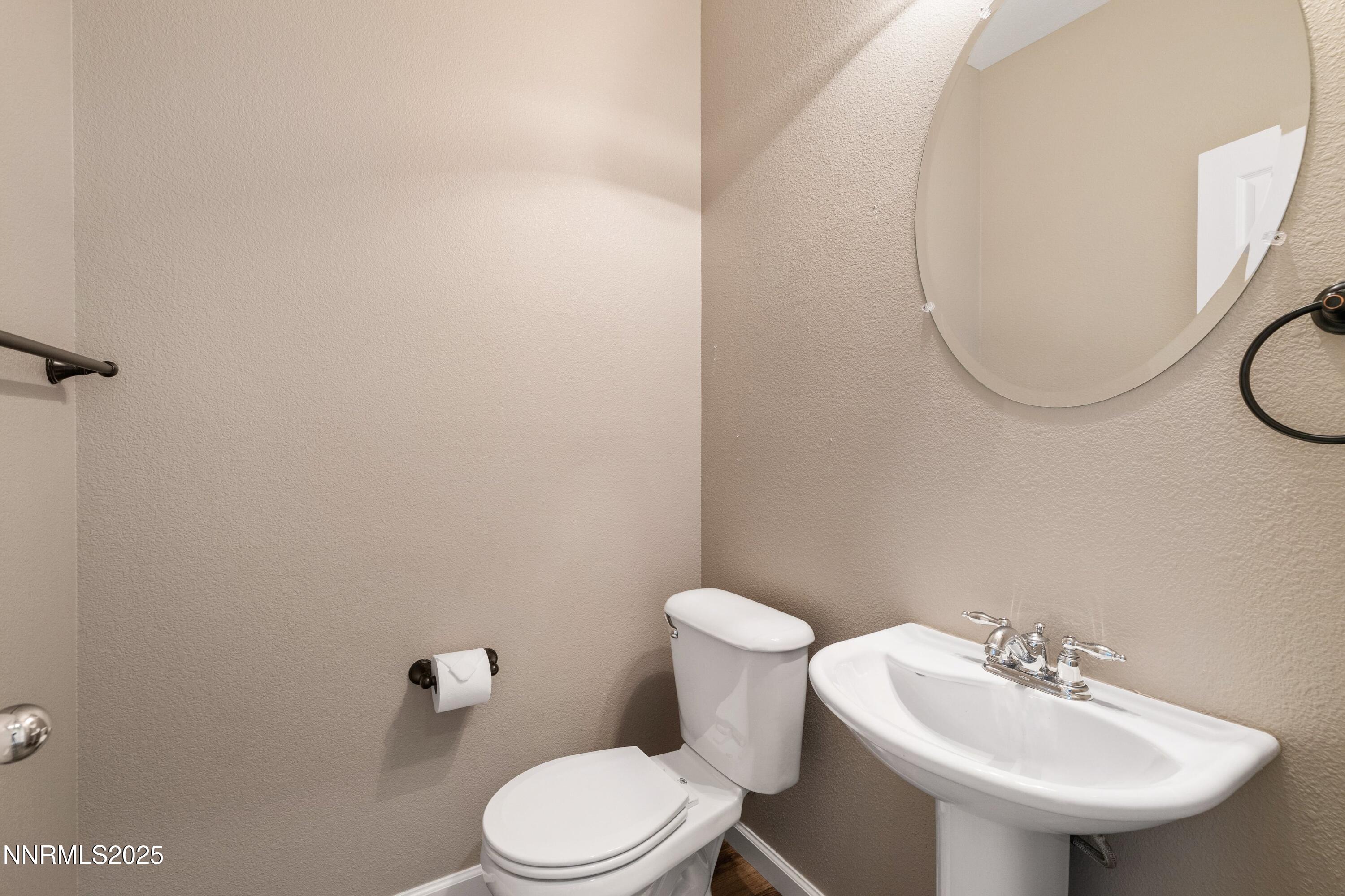 9294 Lone Wolf Circle Reno, NV 89506 - Photo 21 of 25 a bathroom with a sink a toilet and a mirror