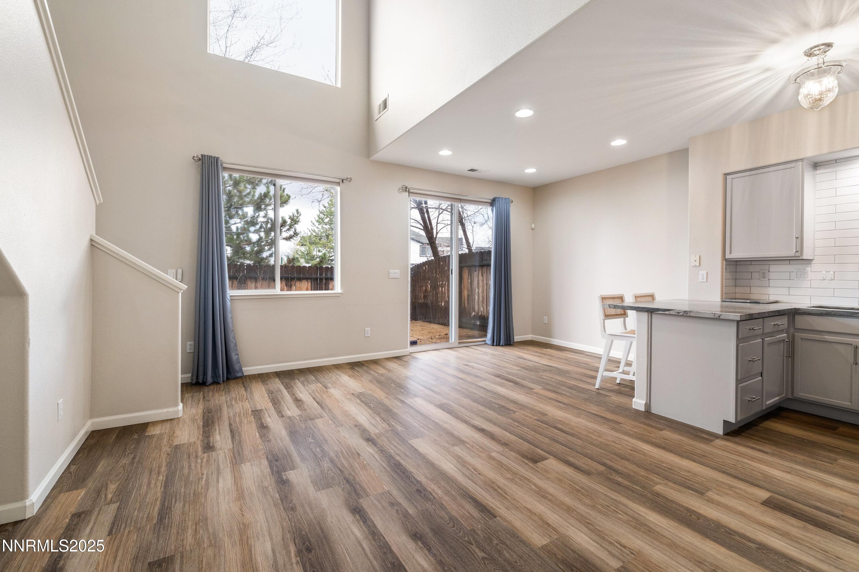 9294 Lone Wolf Circle Reno, NV 89506 - Photo 5 of 25 a view of an empty room with window and wooden floor