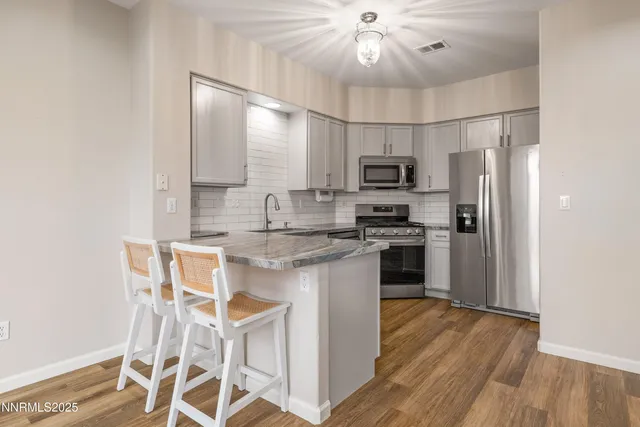 a kitchen with stainless steel appliances a microwave a stove and refrigerator