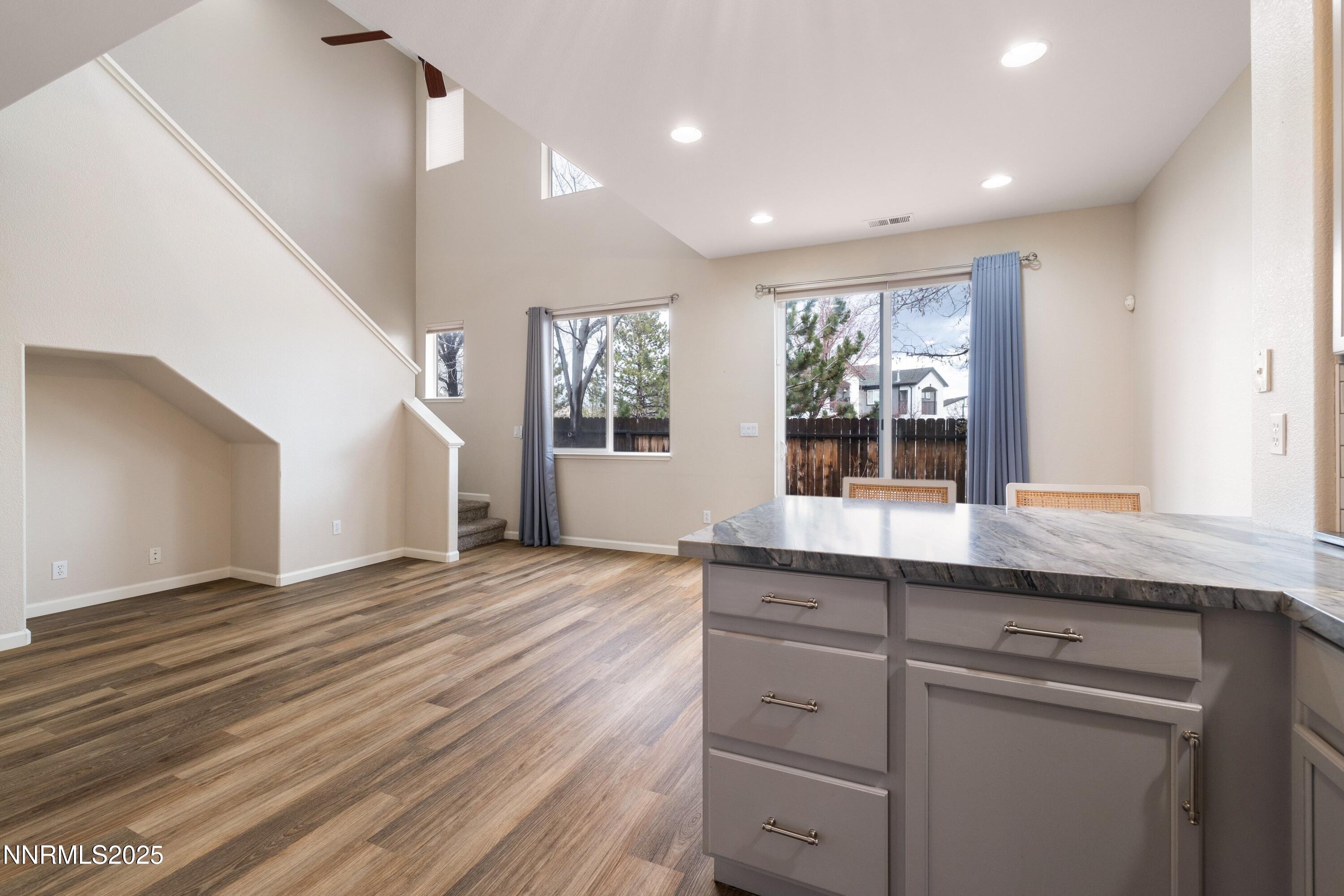 9294 Lone Wolf Circle Reno, NV 89506 - Photo 10 of 25 a kitchen with granite countertop a sink and dishwasher with wooden floor