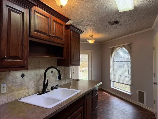 a kitchen with sink and window