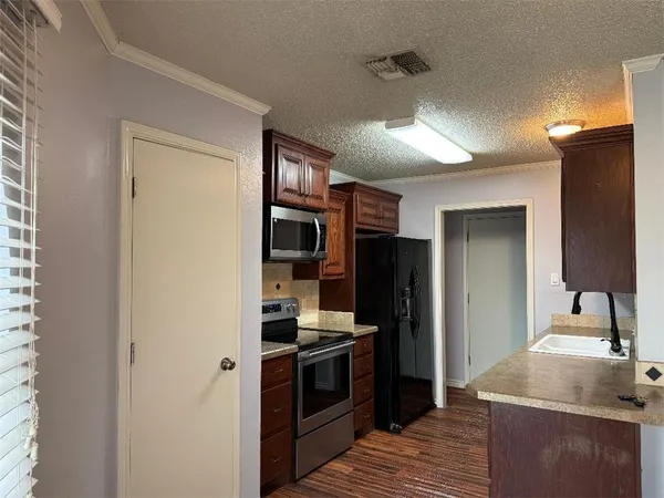 a kitchen with stainless steel appliances granite countertop a refrigerator and a sink