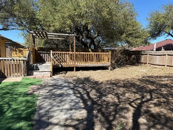 a front view of a house with a yard and tree