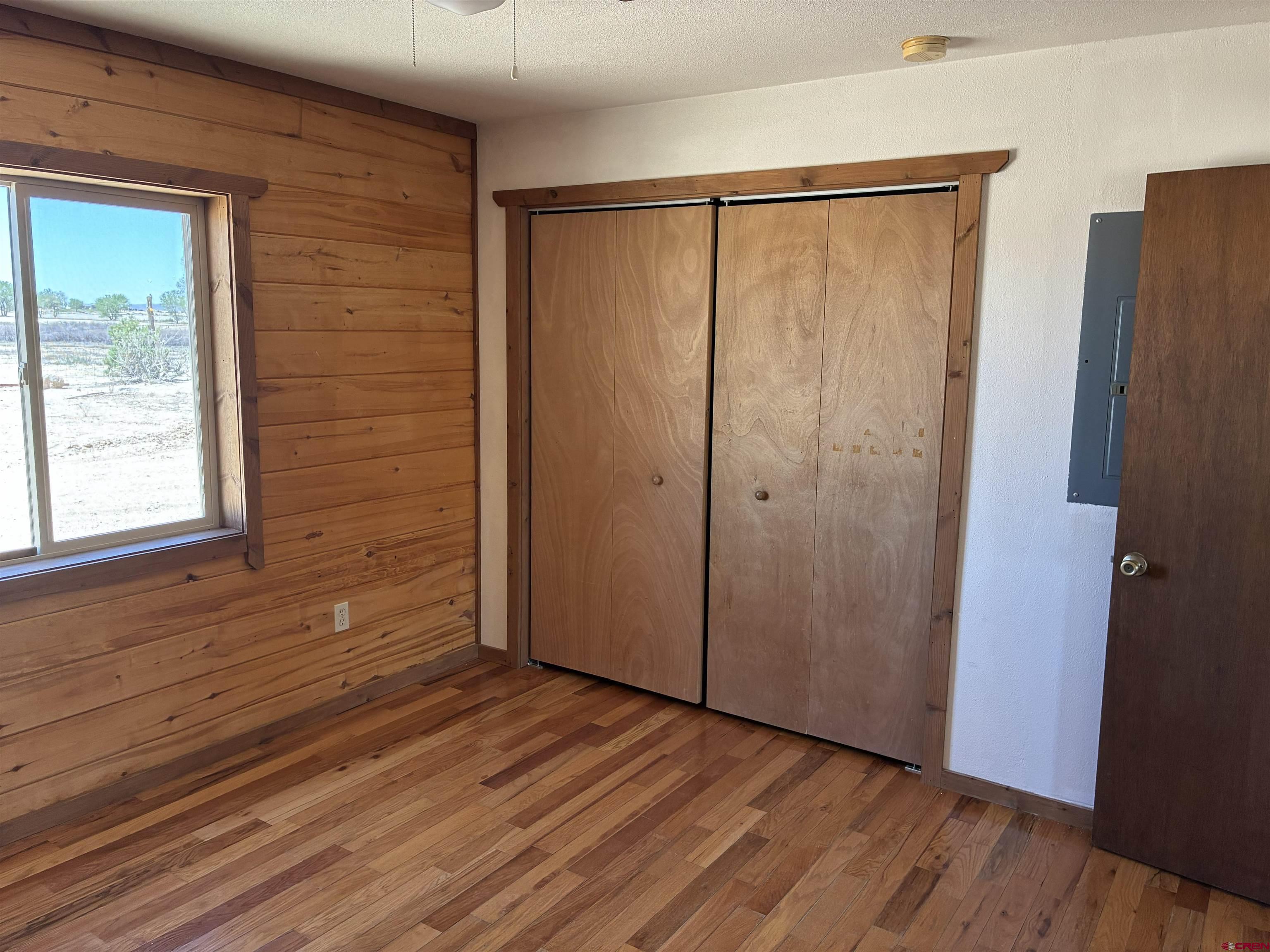 4491 2300th Road Delta, CO 81416 - Photo 11 of 25 a view of an empty room with wooden floor and a window