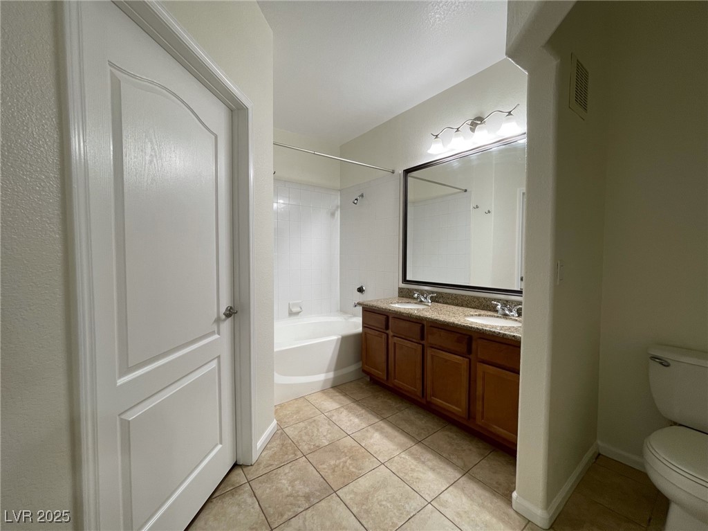 10217 King Henry Avenue, Unit 104 Las Vegas, NV 89144 - Photo 11 of 18 Bathroom featuring shower / bath combination, double vanity, and light tile patterned flooring