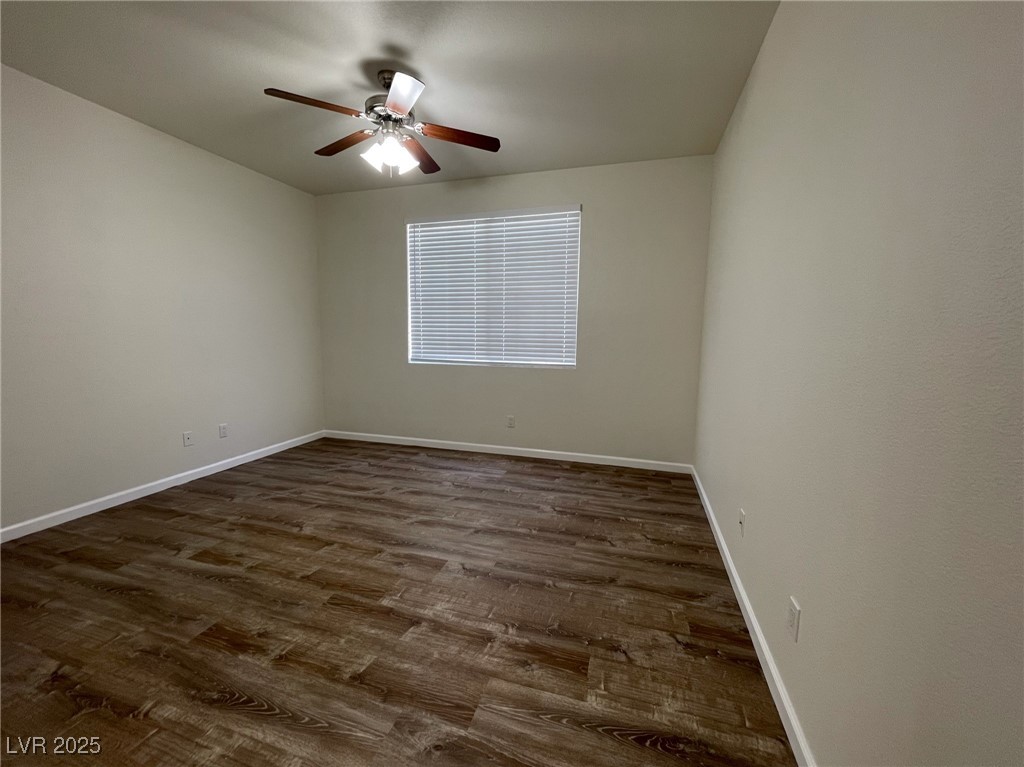 10217 King Henry Avenue, Unit 104 Las Vegas, NV 89144 - Photo 14 of 18 Spare room featuring dark wood-style flooring and a ceiling fan