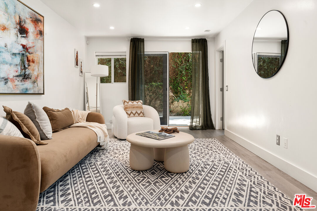 532 North Rossmore Avenue, Unit 107 Los Angeles, CA 90004 - Photo 1 of 12 a living room with furniture and a large window