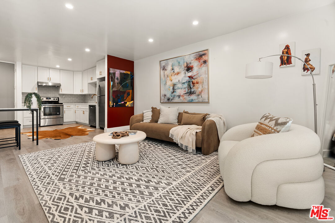 532 North Rossmore Avenue, Unit 107 Los Angeles, CA 90004 - Photo 2 of 12 a living room with furniture and a table