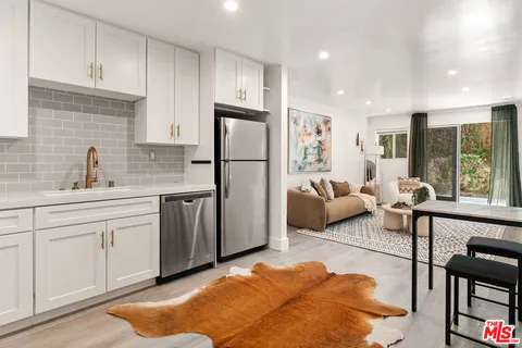 a kitchen with a refrigerator and a sink