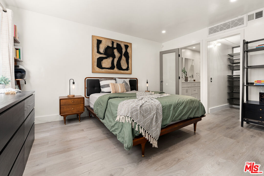 532 North Rossmore Avenue, Unit 107 Los Angeles, CA 90004 - Photo 6 of 12 a bedroom with a bed and dresser