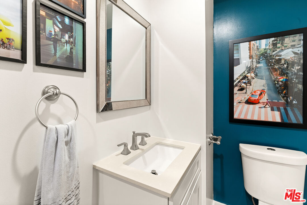 532 North Rossmore Avenue, Unit 107 Los Angeles, CA 90004 - Photo 10 of 12 a bathroom with a toilet sink and mirror