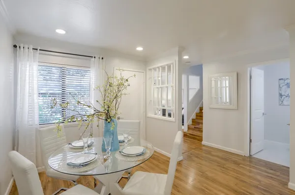 a view of a dining room with furniture window and wooden floor
