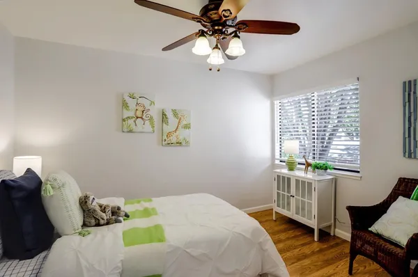 a bedroom with a bed and a window