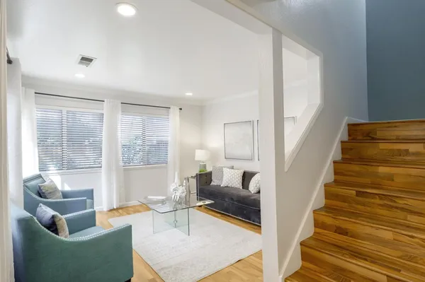 a living room with furniture and a potted plant