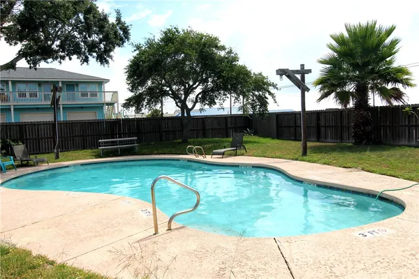 a swimming pool with outdoor seating and yard