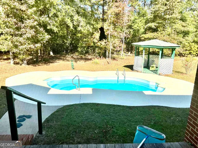 a view of a hallway with furniture and a window