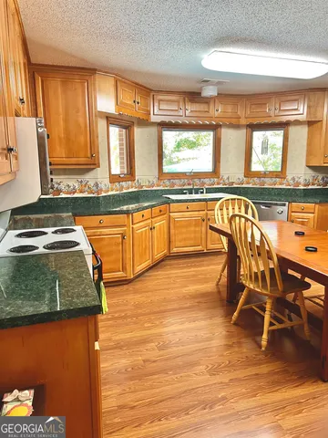 a bathroom with a granite countertop sink and a shower