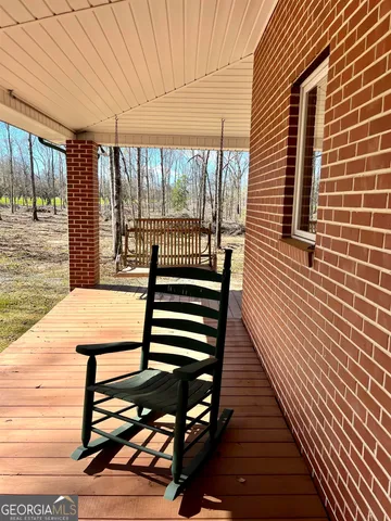a living room with a fireplace and a ceiling fan