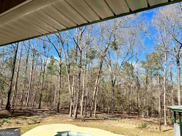 a kitchen with stainless steel appliances granite countertop a stove top oven a sink a dining table and chairs with wooden floor