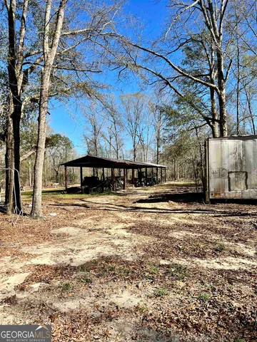a dining hall with stainless steel appliances granite countertop a stove and a dining table with wooden floor