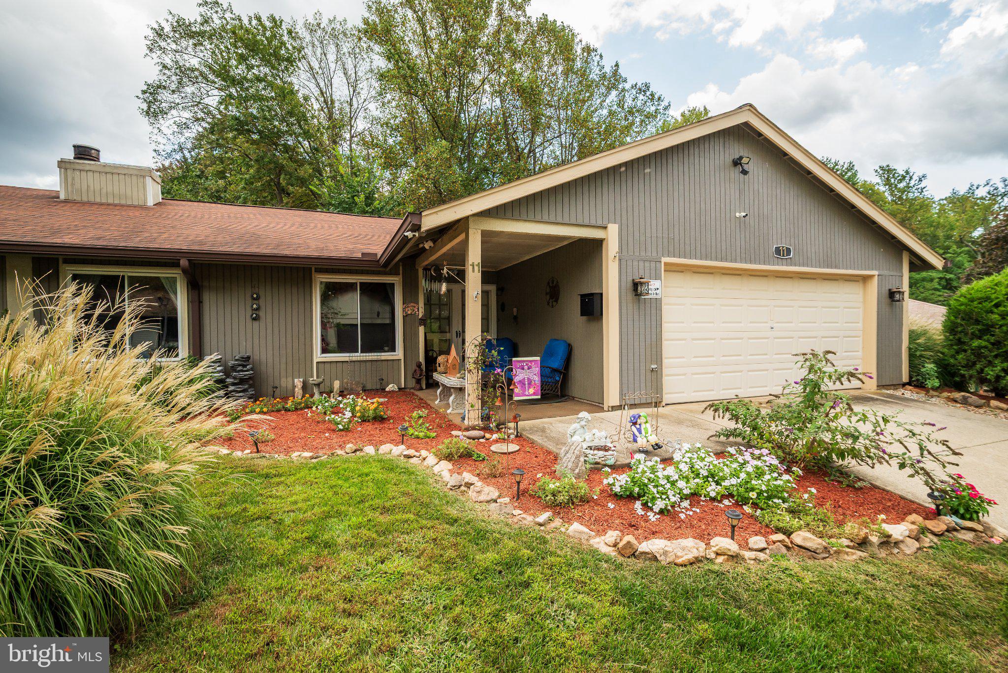 Charming home with vibrant landscaping.