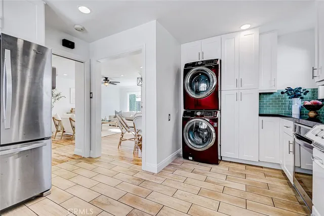 a view of washer and dryer with kitchen in the background