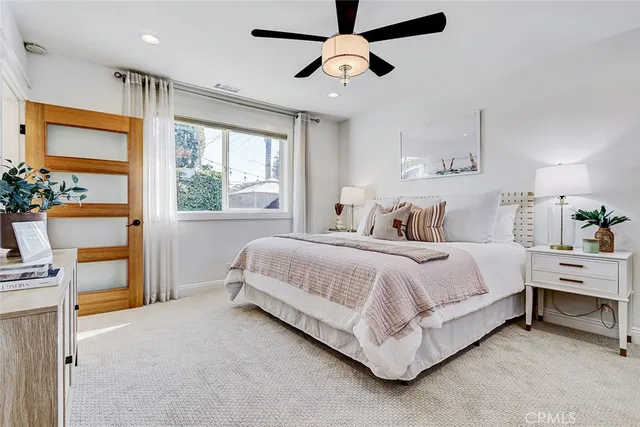 a spacious bedroom with a bed and a window