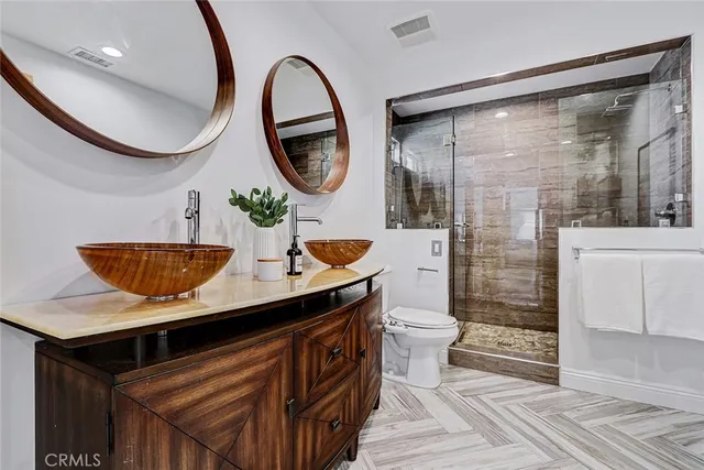 a bathroom with a sink a mirror and a shower