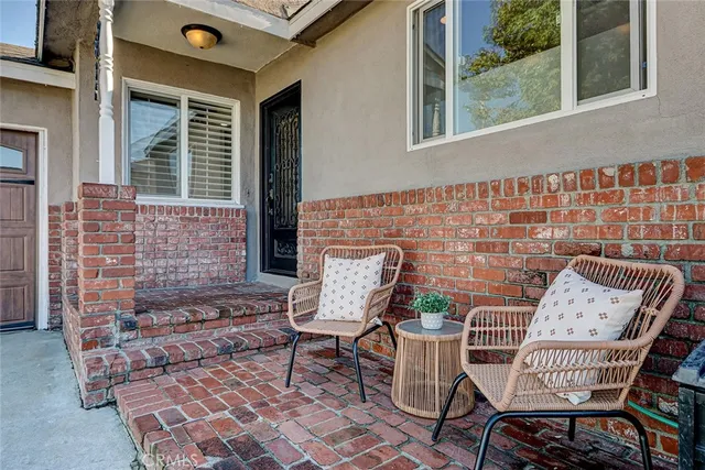 a view of a chair and table in the back of the house