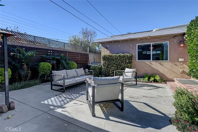 a patio with glass table and chairs