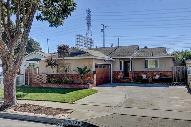 a view of house with a yard and parking space