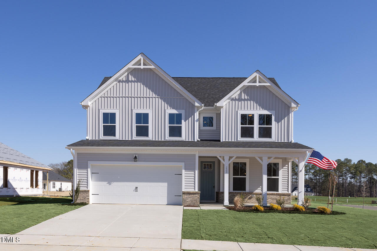 233 Tenure Lane Lillington, NC 27546 - Photo 1 of 30 a front view of a house with a yard