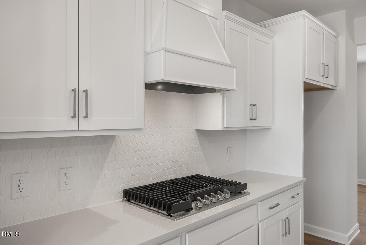 233 Tenure Lane Lillington, NC 27546 - Photo 10 of 30 a kitchen with white cabinets and stove