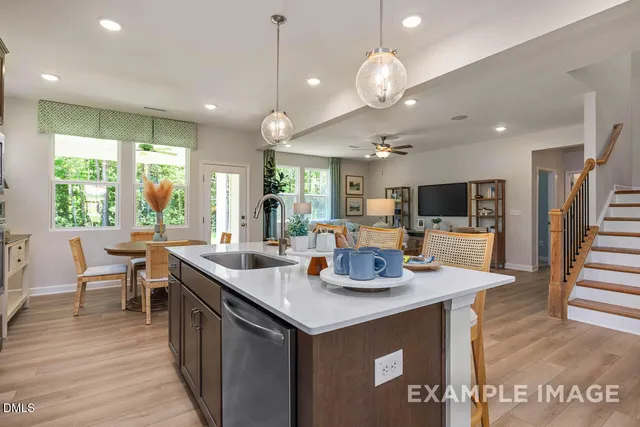 a kitchen with stainless steel appliances granite countertop a stove and cabinets
