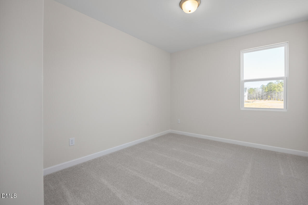 233 Tenure Lane Lillington, NC 27546 - Photo 14 of 30 an empty room with a window
