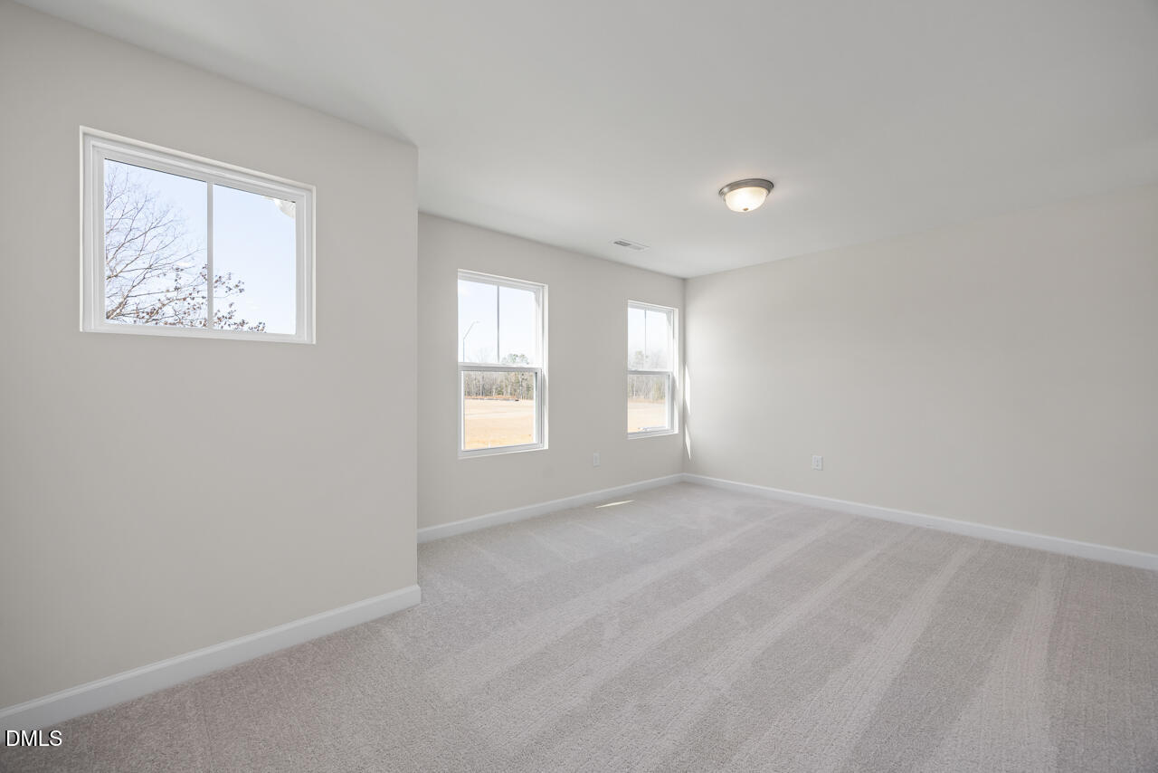 233 Tenure Lane Lillington, NC 27546 - Photo 15 of 30 an empty room with windows